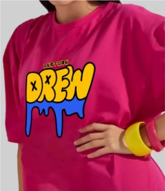 Person wearing a bright pink sweatshirt with colorful text design on a plain background