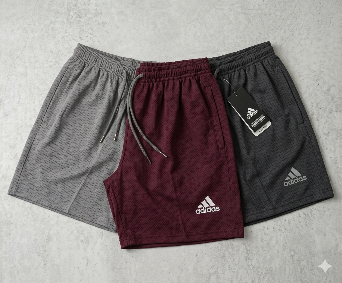 Three pairs of  shorts in gray, maroon, and black on a light gray background.