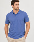 Man wearing a blue polo shirt against a plain background