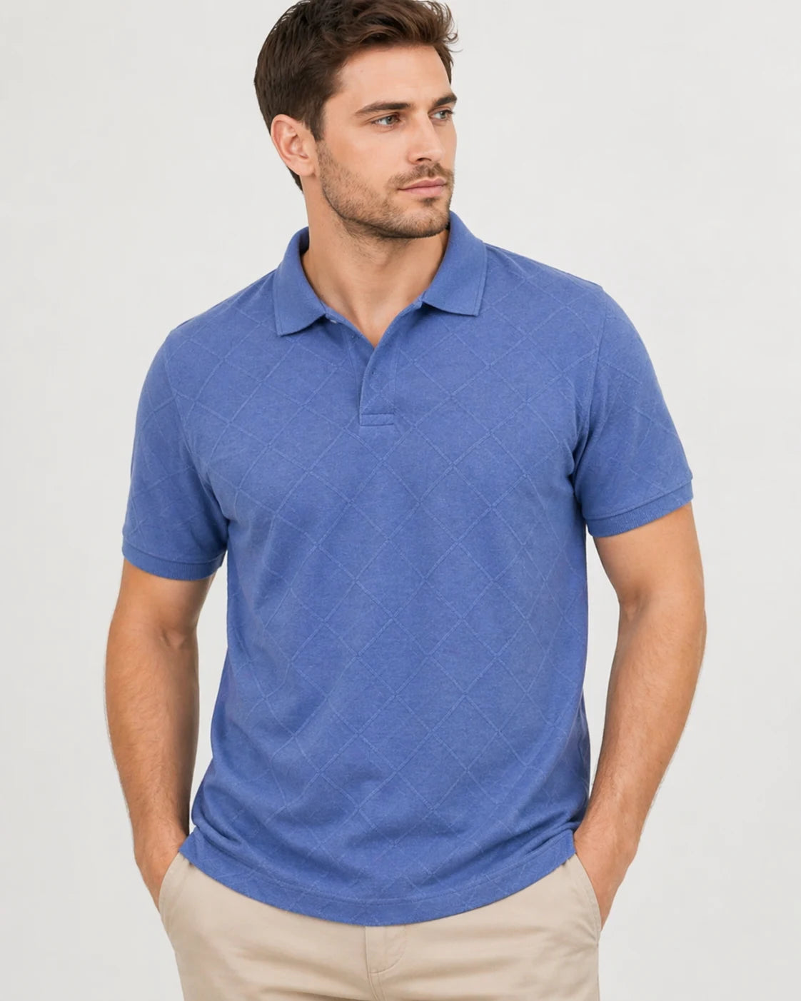 Man wearing a blue polo shirt against a plain background
