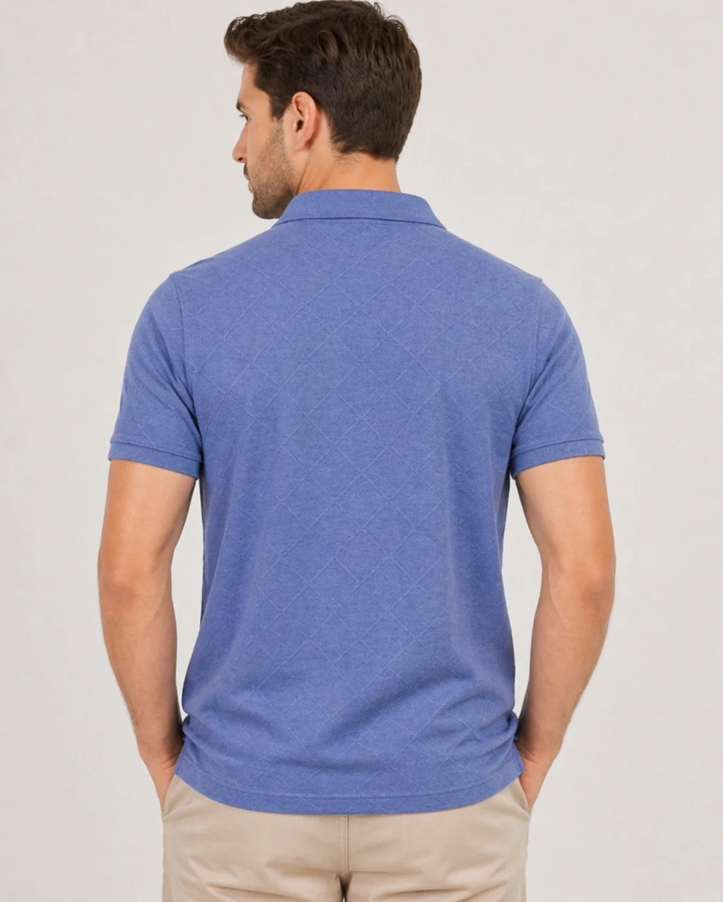 Man wearing a blue 200 gsm polo shirt on a plain background and showing the back of the tshirt