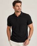 Man wearing a black polo shirt against a plain background