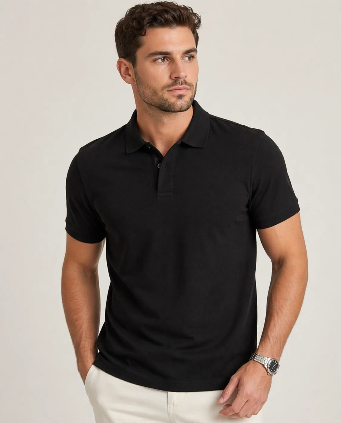 Man wearing a black polo shirt against a plain background