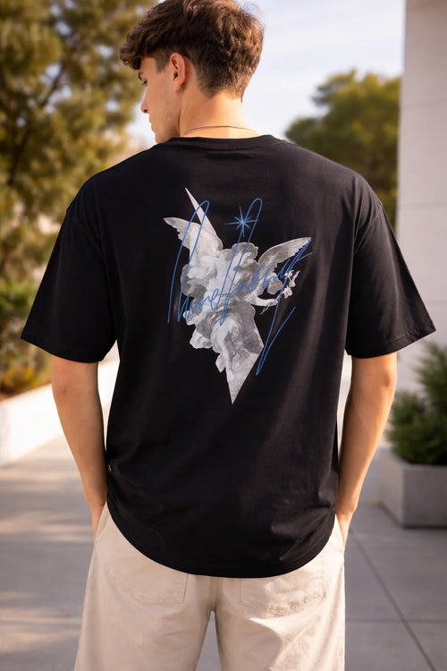 man wearing black oversized t-shirt with angel graphic back print 240 GSM heavy cotton India