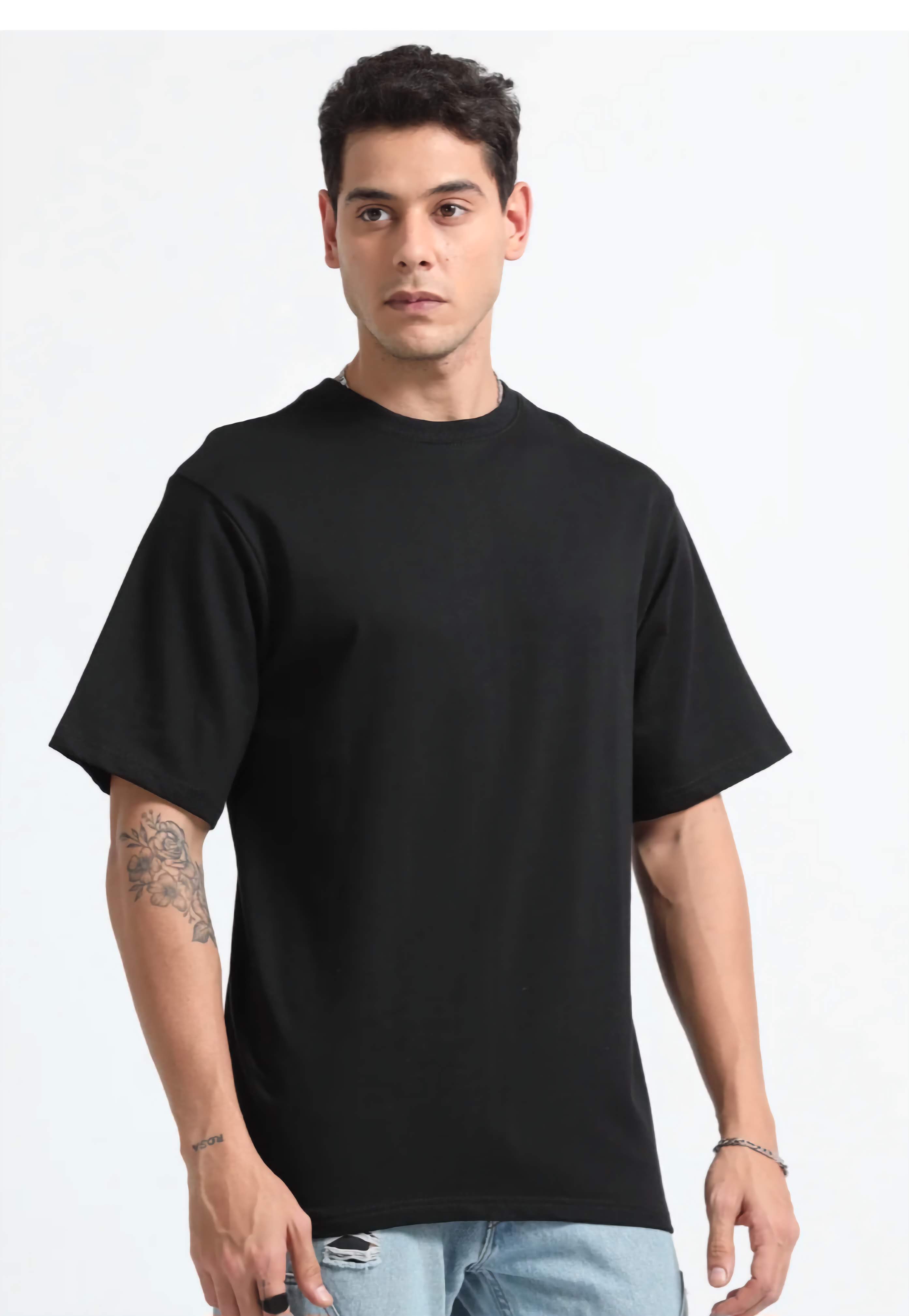 Man wearing a plain black t-shirt on a white background