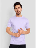 Man wearing a light purple t-shirt against a plain background