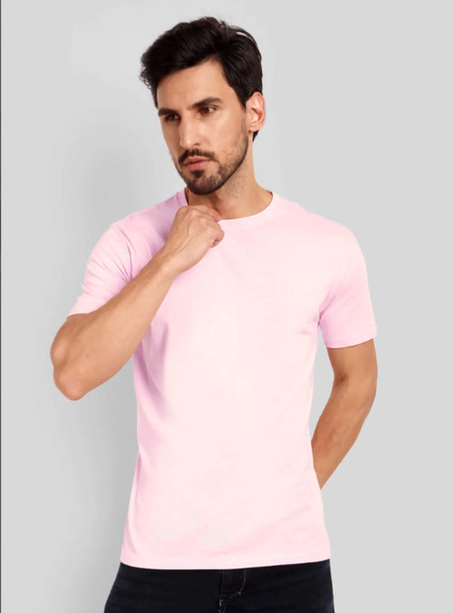 Man wearing a pink t-shirt against a gray background
