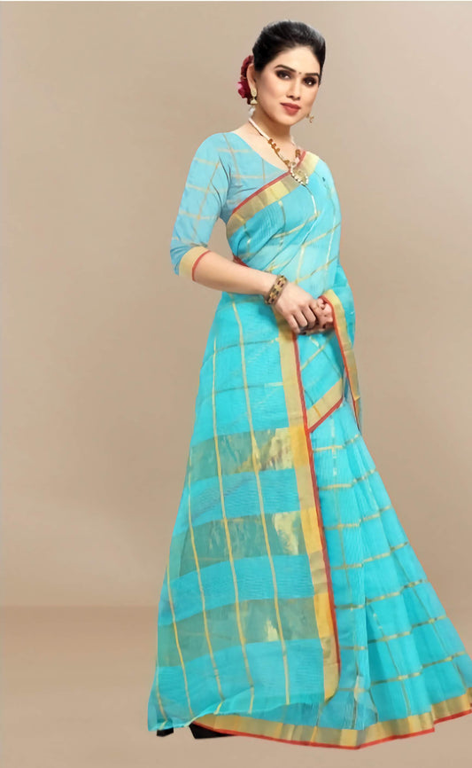 Woman wearing a blue saree with gold border on a beige background