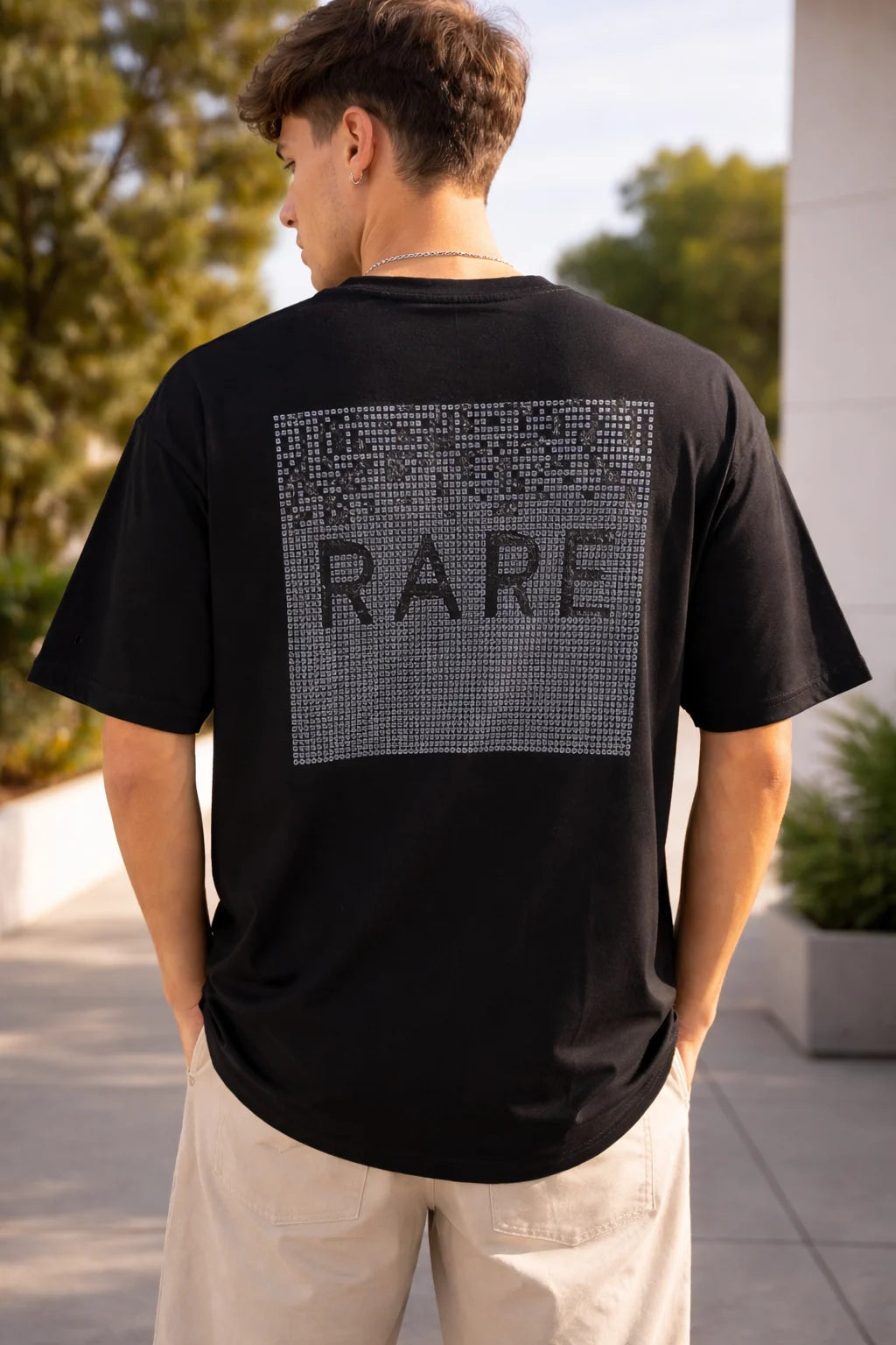 man wearing black oversized t-shirt with minimal RARE graphic back print 240 GSM cotton India