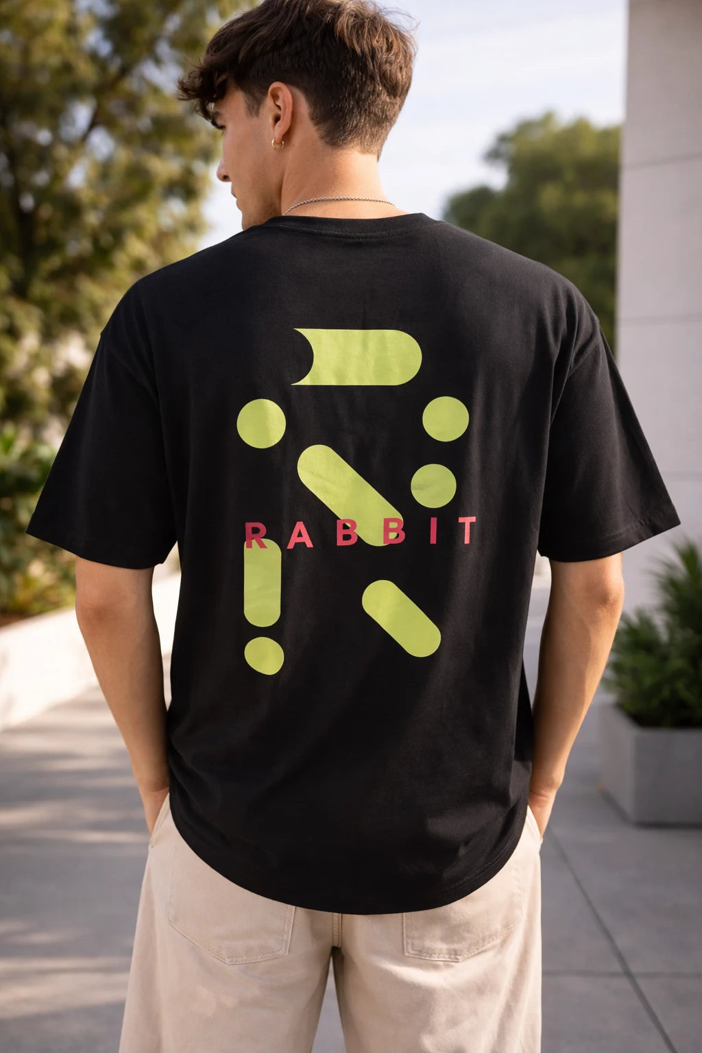 man wearing black oversized t-shirt with neon rabbit graphic back print 240 GSM cotton India